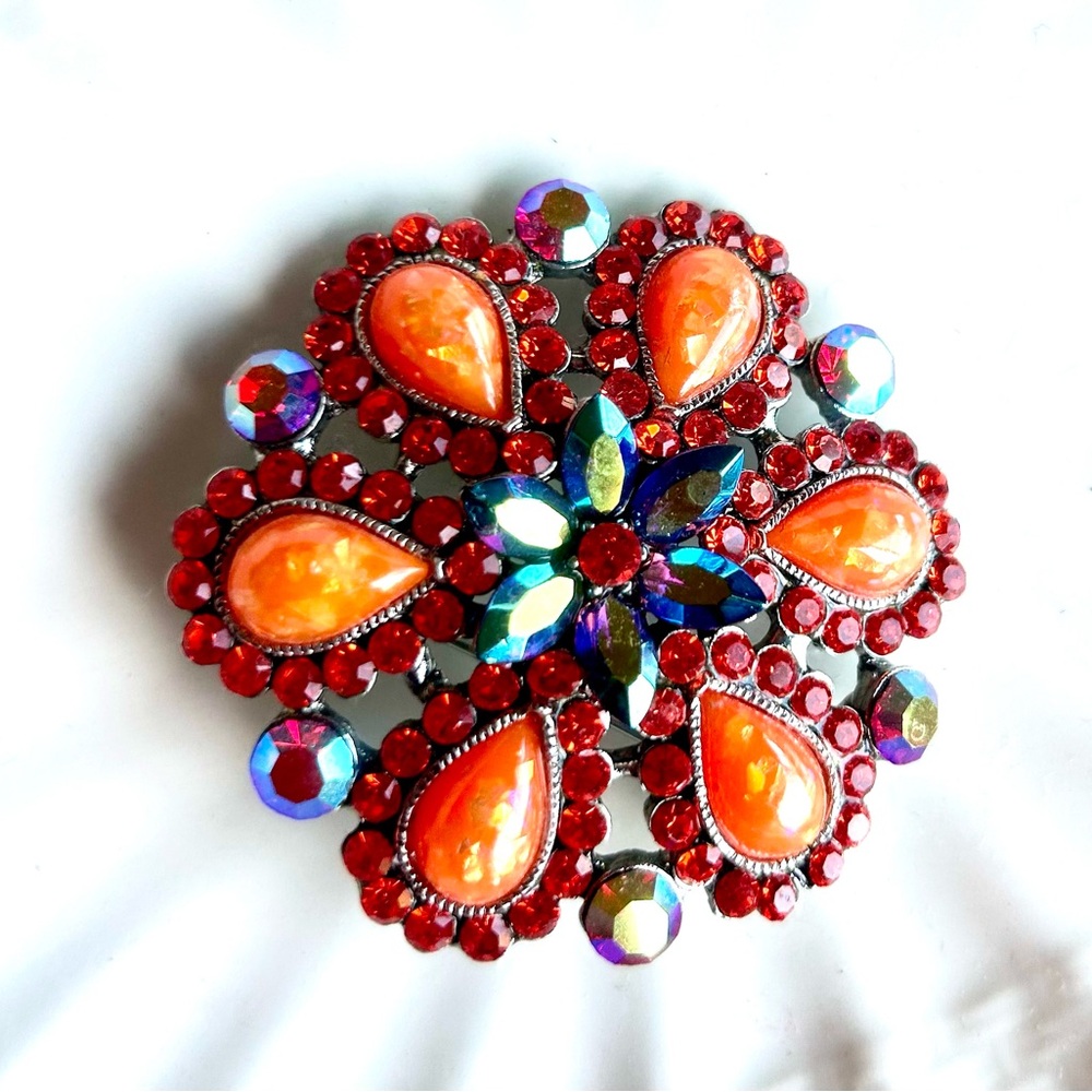 NWOT.  Cara Women’s Iridescent Orange, Red & Blue Floral Design Crystal Brooch.